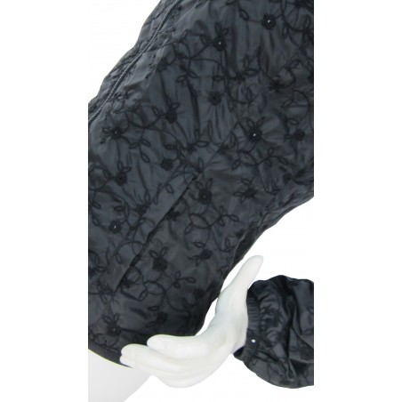 Woman jacket with zip pockets and belt with buckle.