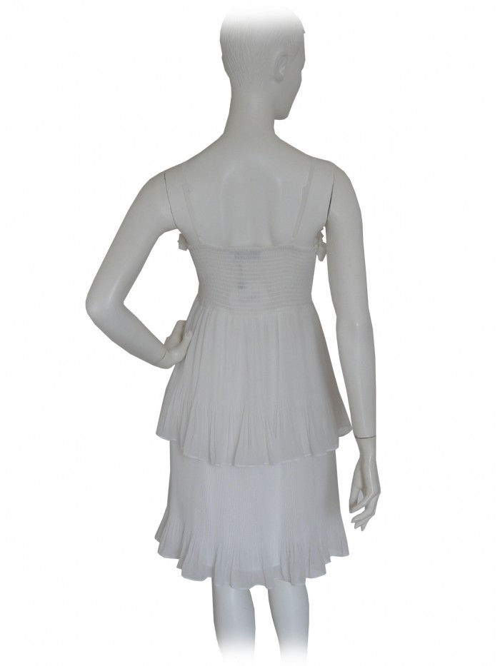 Woman dress with shoulder strap and bodice with pleated flounce.