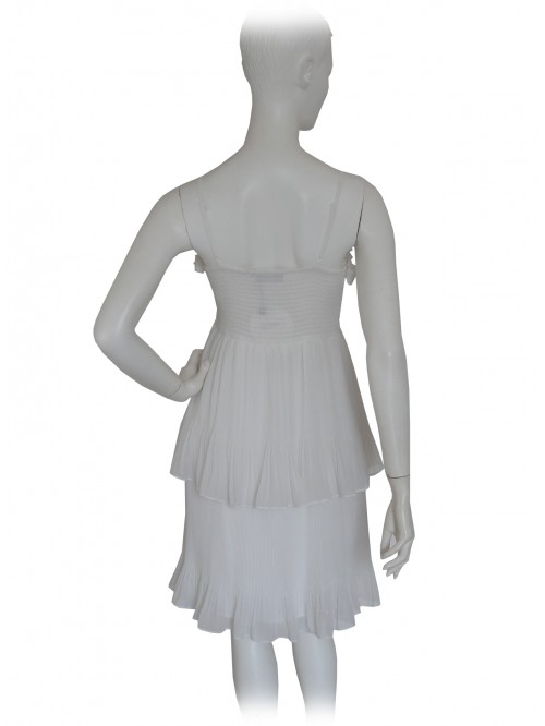 Woman dress with shoulder strap and bodice with pleated flounce.