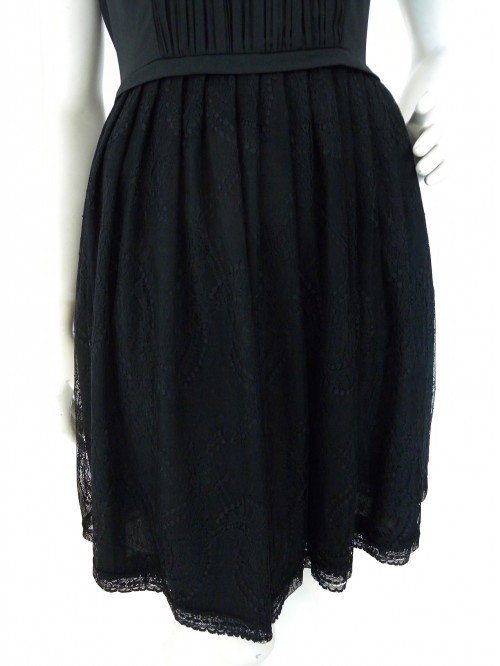 Woman dress with pleated bodice and lace skirt.
