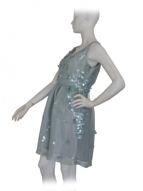 Elegant woman dress, round neckline with sequin inserts on the same color