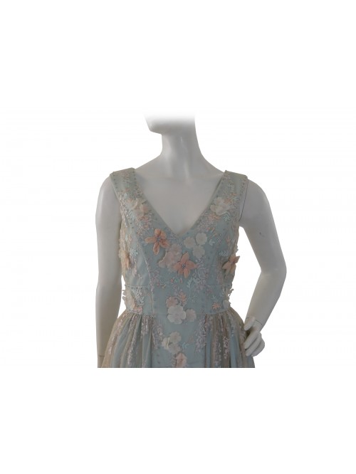 Elegant woman dress, lace with flowers applied ecru on green