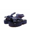 Woman sandals with wedge, glossy effect with asymmetrical knot decoration.