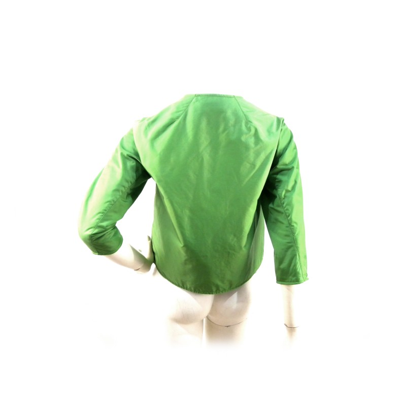 Short double-breasted Aba woman jacket round neck with visible pockets.