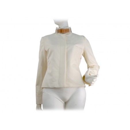 Slim short women's jacket with high collar and contrasting leather belt. Slim short women's jacket with high collar and contrasting leather belt.